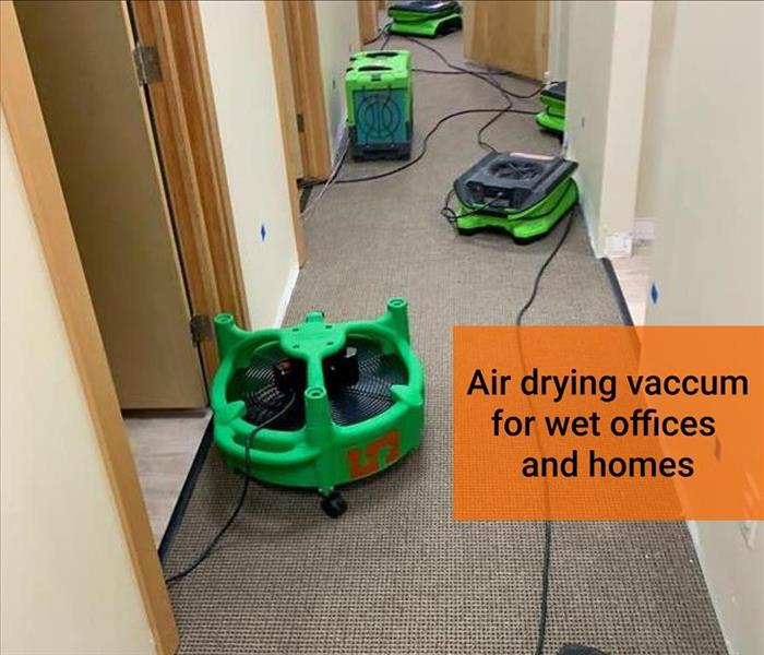 air drying fans on a wet carpet in an office