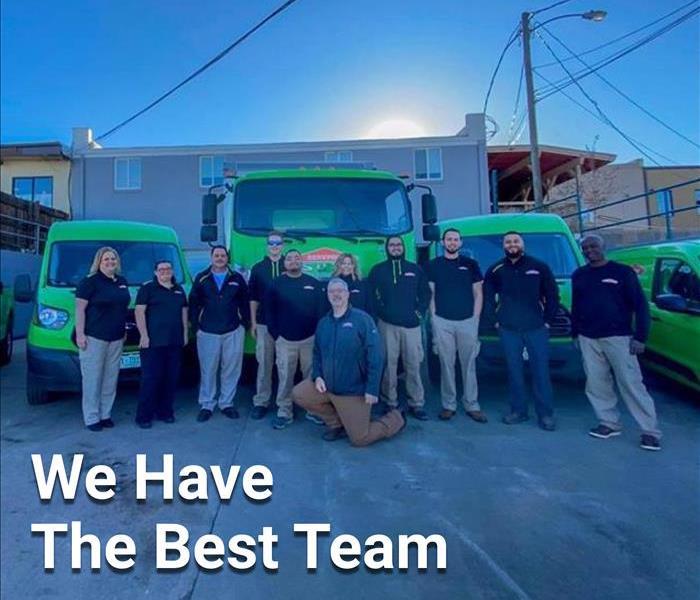 SERVPRO team members in front of SERVPRO vehicles